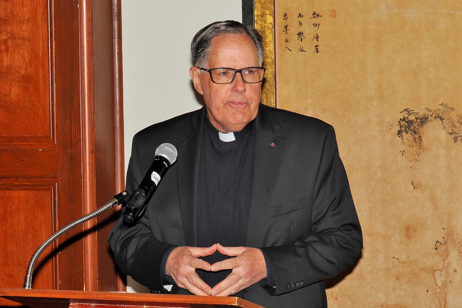 Father Shanley speaking at the podium